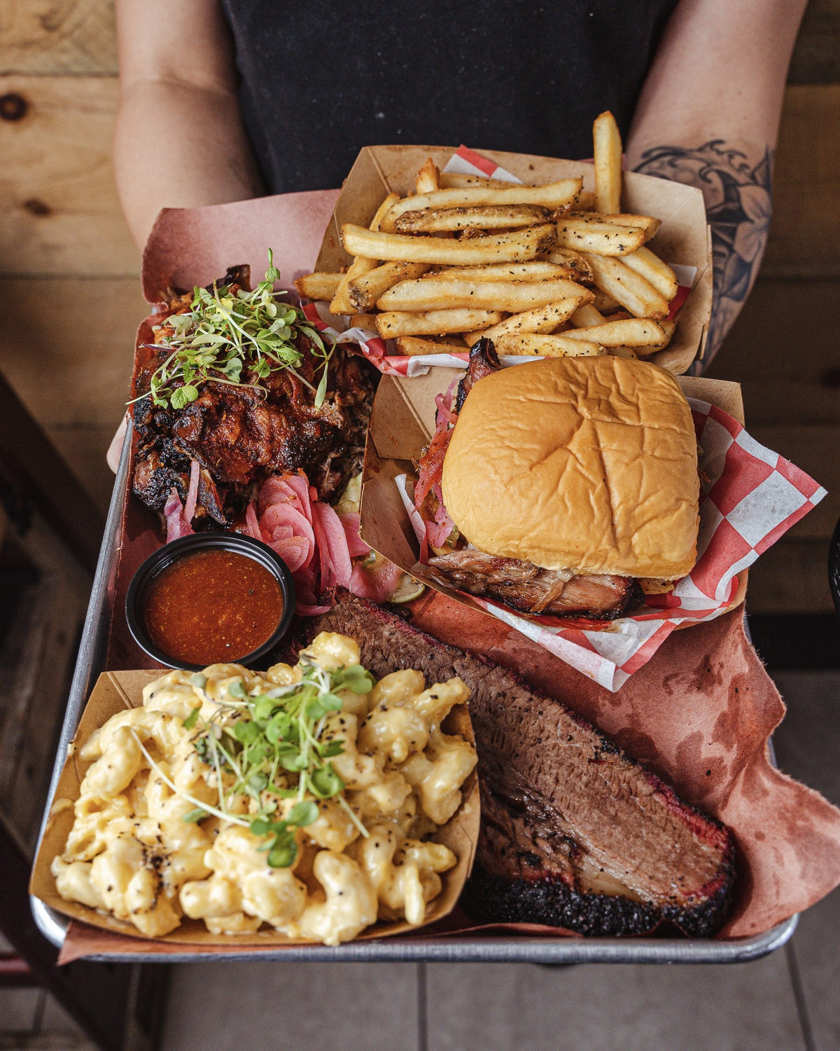Tray with brisket, mac and cheese, a burger and fries